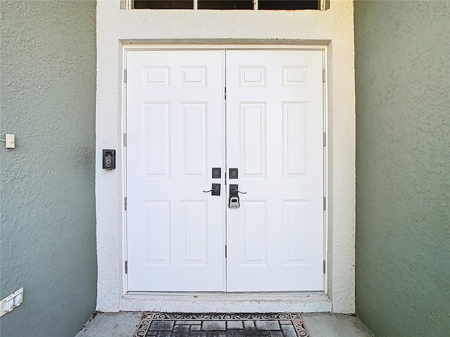 entrance to property with stucco siding