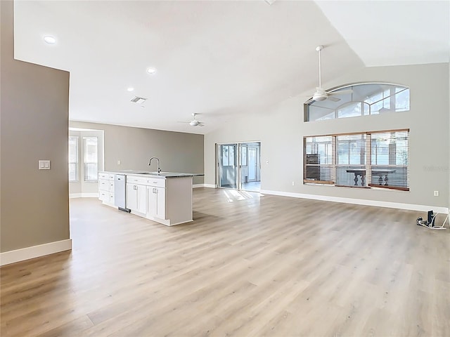 unfurnished living room with visible vents, baseboards, light wood-style flooring, and a ceiling fan