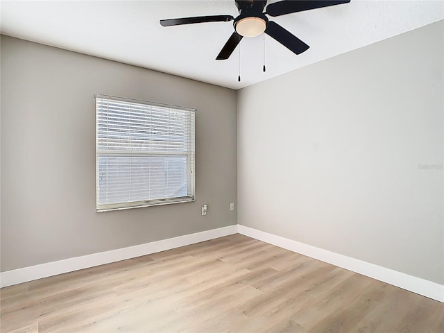 empty room with baseboards, light wood-style floors, and a ceiling fan