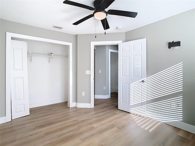 unfurnished bedroom with visible vents, baseboards, light wood-style floors, a closet, and a ceiling fan