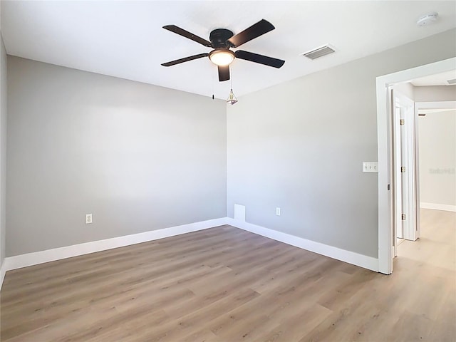 spare room with visible vents, baseboards, light wood-style floors, and ceiling fan