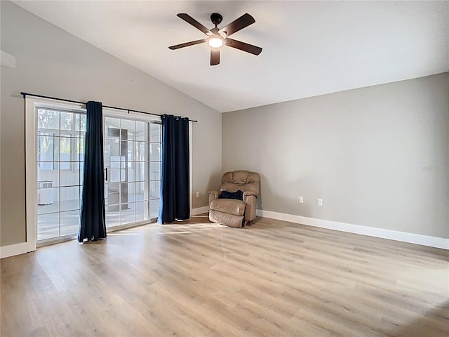 unfurnished room with baseboards, a ceiling fan, lofted ceiling, and wood finished floors