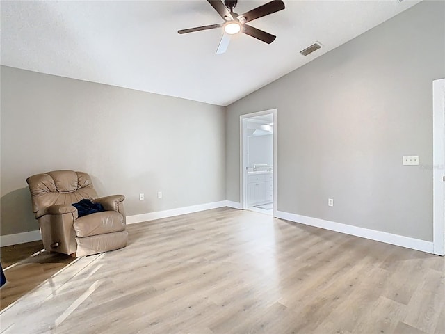 unfurnished room featuring visible vents, baseboards, vaulted ceiling, light wood-style flooring, and a ceiling fan