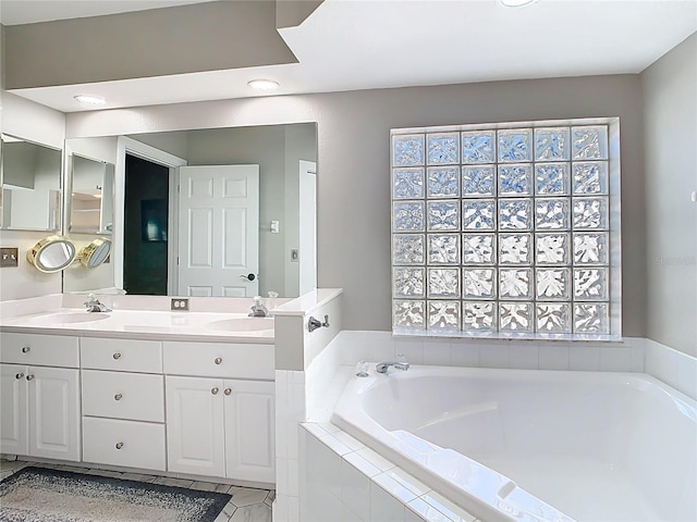 full bathroom with a bath, a healthy amount of sunlight, and a sink