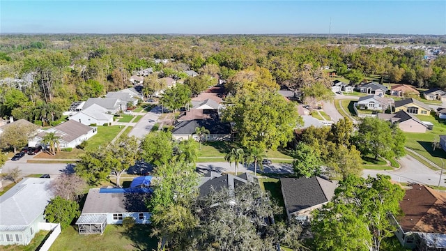 aerial view featuring a forest view and a residential view