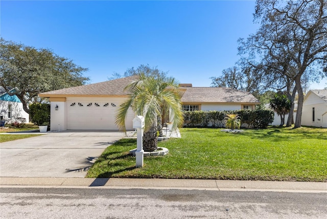 view of front of house featuring stucco siding, driveway, a front yard, and an attached garage