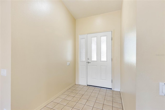 foyer entrance featuring baseboards and light tile patterned flooring