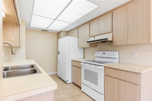 kitchen with under cabinet range hood, white appliances, light brown cabinets, and a sink