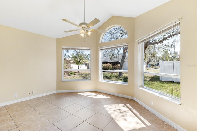 tiled spare room featuring vaulted ceiling, baseboards, and ceiling fan