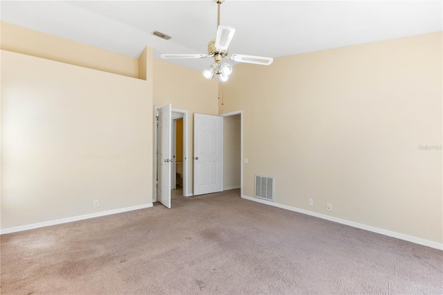 carpeted empty room with visible vents, baseboards, and a ceiling fan