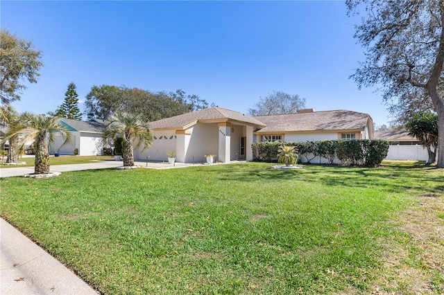 view of front of home featuring stucco siding, a front lawn, fence, concrete driveway, and a garage