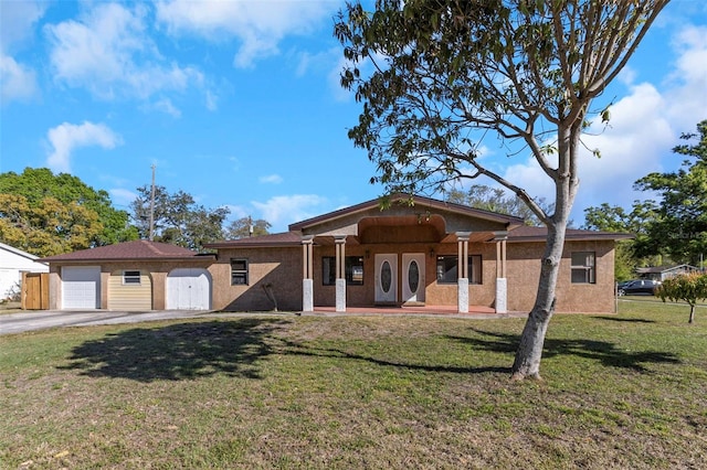 ranch-style home featuring a front lawn, concrete driveway, and an attached garage