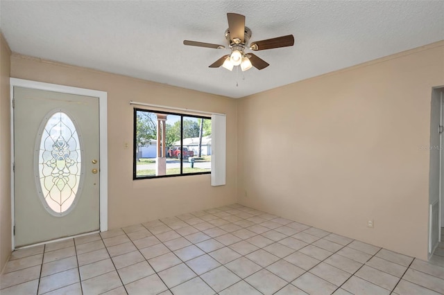 foyer entrance with a textured ceiling and ceiling fan