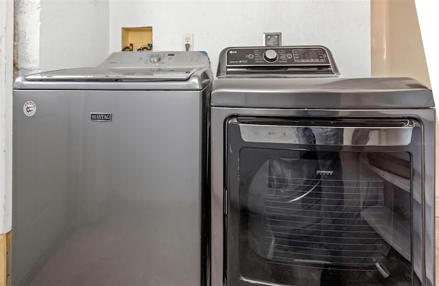 laundry area with separate washer and dryer and laundry area