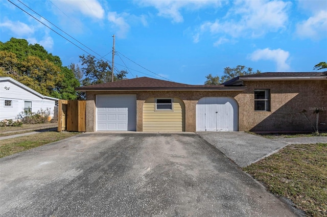 garage featuring aphalt driveway