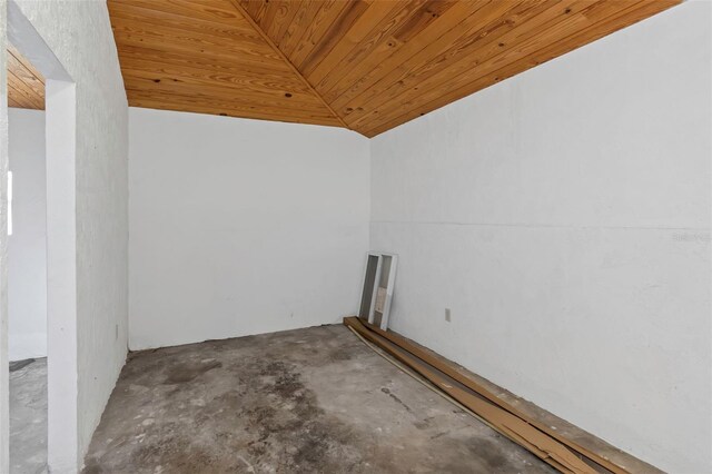 interior space with wood ceiling, concrete flooring, and vaulted ceiling