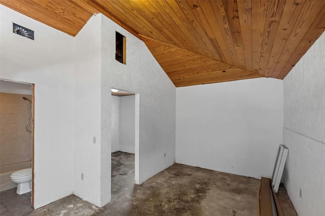 bonus room featuring lofted ceiling, unfinished concrete flooring, and wooden ceiling