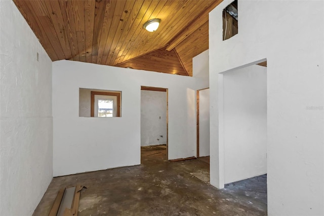 unfurnished room featuring concrete flooring, wooden ceiling, and vaulted ceiling