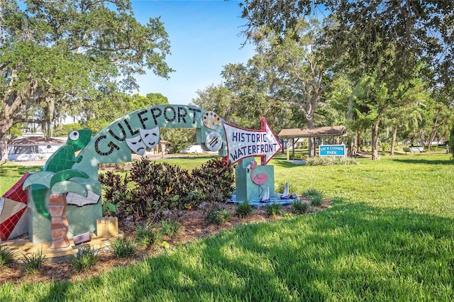 community / neighborhood sign featuring a yard