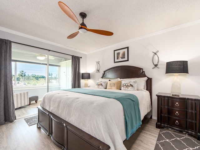 bedroom with radiator, a ceiling fan, wood finished floors, ornamental molding, and a textured ceiling