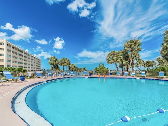 view of pool featuring fence