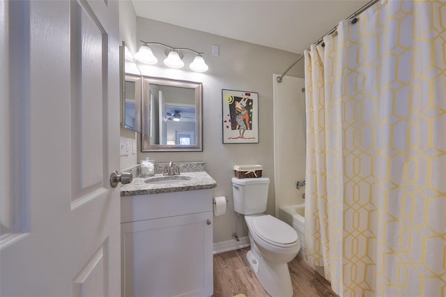 full bath featuring toilet, wood finished floors, shower / bath combination with curtain, vanity, and a ceiling fan