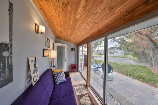 sunroom / solarium featuring lofted ceiling and wood ceiling