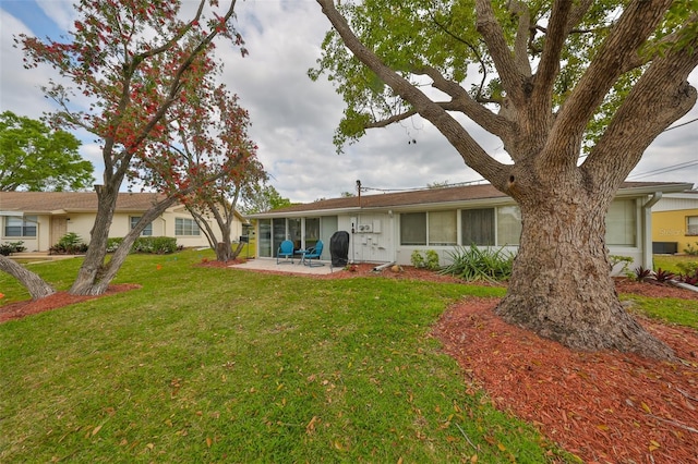 back of property with a patio area and a lawn