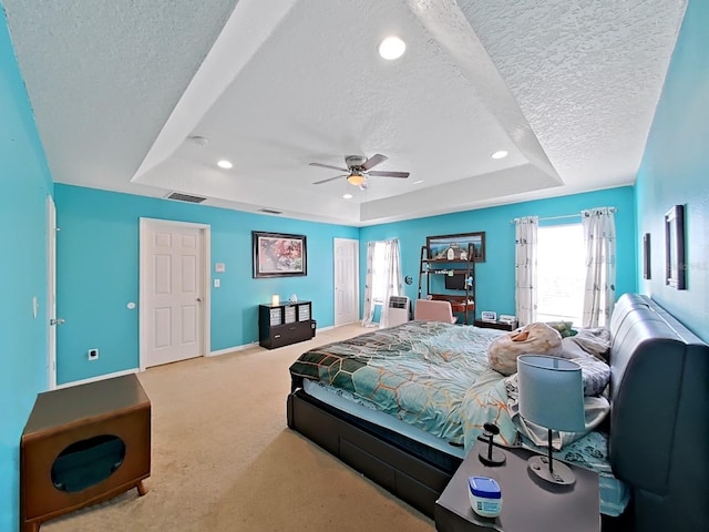 bedroom featuring a raised ceiling, carpet, baseboards, and a textured ceiling