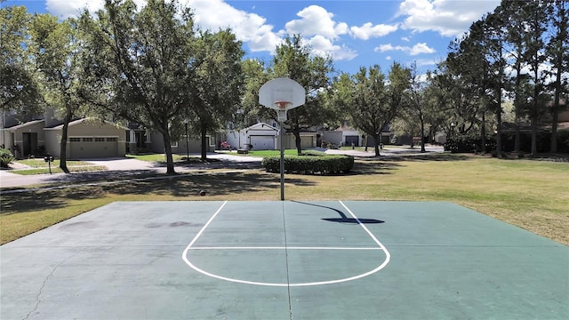 view of basketball court featuring a yard and a residential view