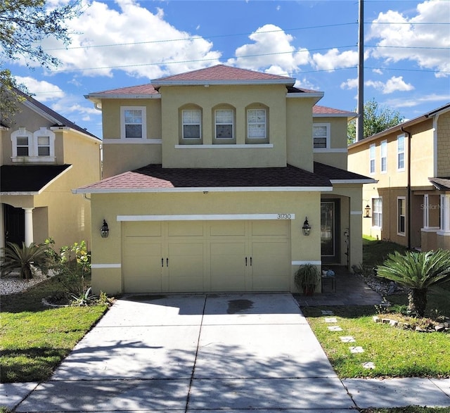 31730 Spoonflower Cir, Wesley Chapel, FL 33545 - mediterranean / spanish-style house featuring a garage, driveway, and stucco siding
