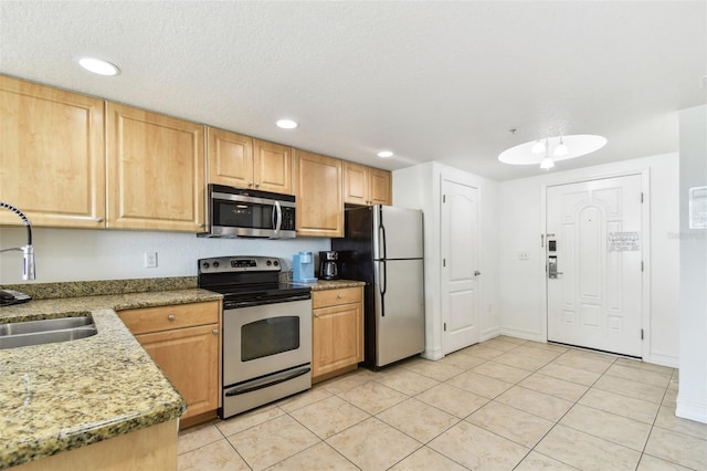 kitchen with light tile patterned flooring, recessed lighting, appliances with stainless steel finishes, and a sink