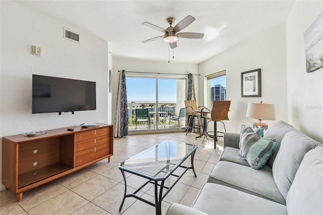 living area featuring visible vents, ceiling fan, and light tile patterned flooring