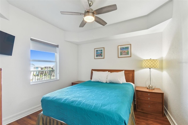 bedroom with ceiling fan, baseboards, and wood finished floors