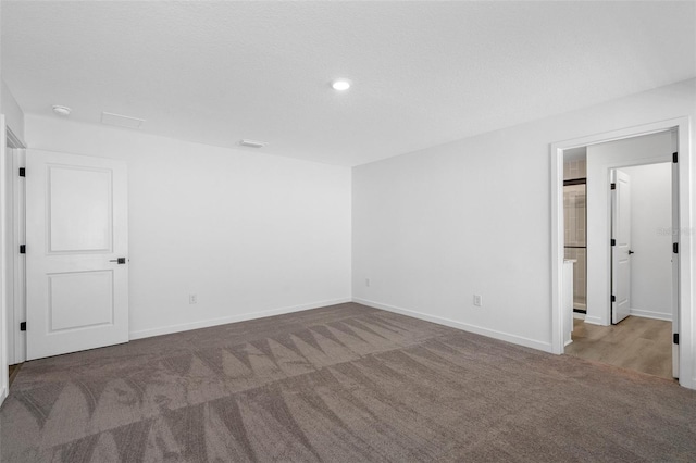 unfurnished bedroom with visible vents, recessed lighting, baseboards, and carpet floors