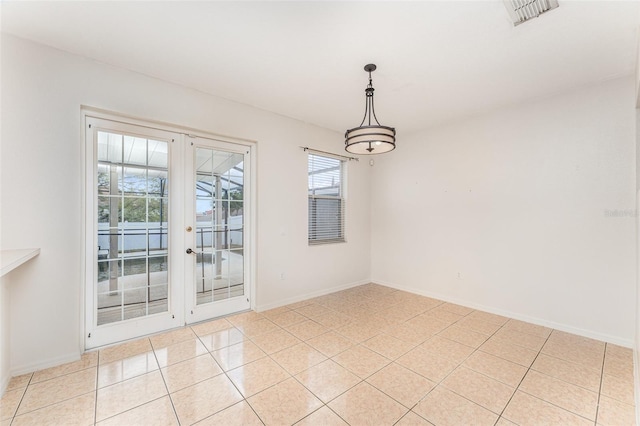 spare room featuring light tile patterned floors, visible vents, french doors, and baseboards