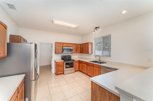 kitchen with visible vents, a sink, stainless steel appliances, light countertops, and light tile patterned floors