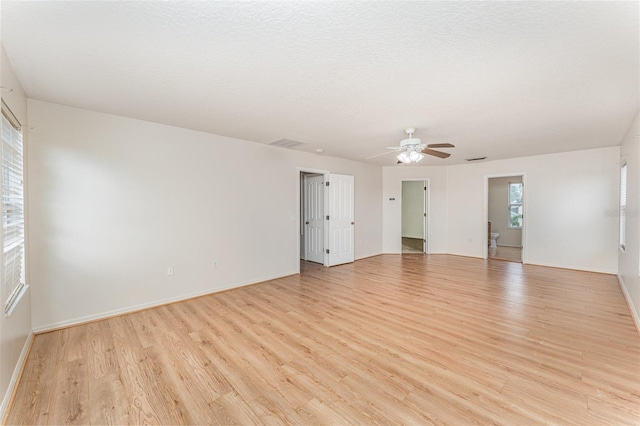 unfurnished room featuring visible vents, baseboards, ceiling fan, and light wood finished floors