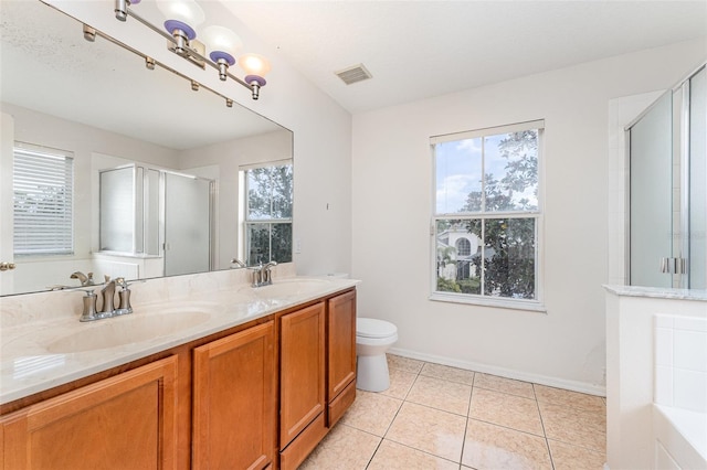 full bathroom with tile patterned floors, a stall shower, double vanity, and a sink