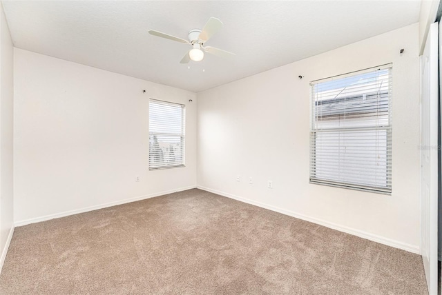 unfurnished room with baseboards, carpet floors, and ceiling fan