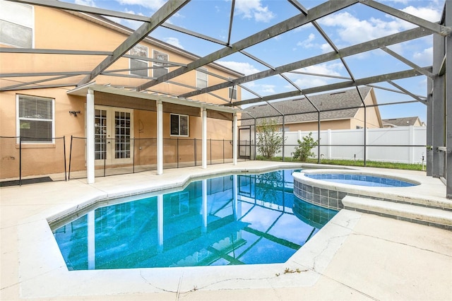 view of swimming pool with a pool with connected hot tub, fence, a lanai, french doors, and a patio area