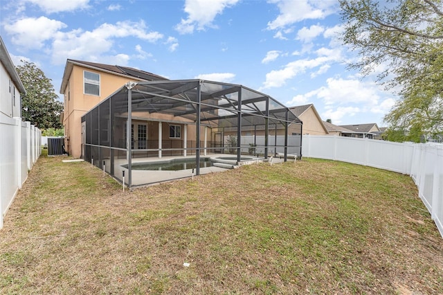 rear view of property featuring central air condition unit, a patio, a yard, and a fenced backyard