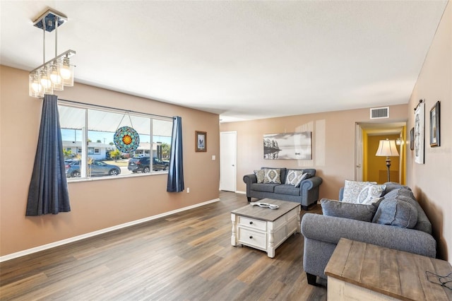 1021 Augusta Dr, Sun City Center, FL 33573 - living area with dark wood finished floors, visible vents, and baseboards