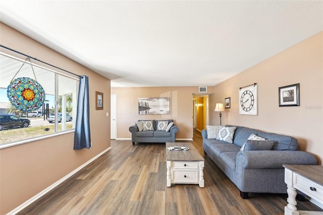 1021 Augusta Dr, Sun City Center, FL 33573 - living room featuring visible vents, baseboards, and wood finished floors