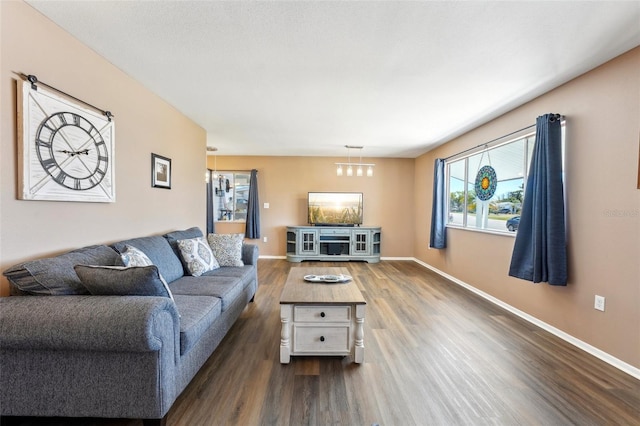 1021 Augusta Dr, Sun City Center, FL 33573 - living room featuring dark wood-style floors and baseboards