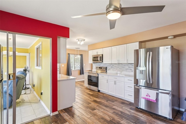 1021 Augusta Dr, Sun City Center, FL 33573 - kitchen with white cabinetry, light countertops, tasteful backsplash, and stainless steel appliances