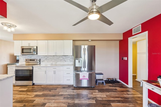 1021 Augusta Dr, Sun City Center, FL 33573 - kitchen featuring visible vents, backsplash, light countertops, appliances with stainless steel finishes, and dark wood-style flooring