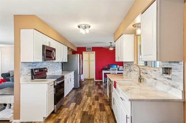 1021 Augusta Dr, Sun City Center, FL 33573 - kitchen featuring backsplash, dark wood-style floors, white cabinetry, appliances with stainless steel finishes, and ceiling fan