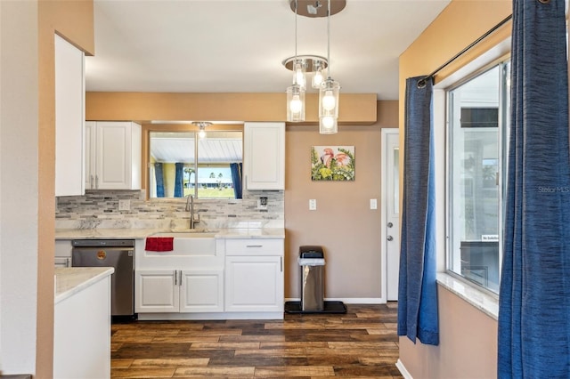 1021 Augusta Dr, Sun City Center, FL 33573 - kitchen with decorative backsplash, dishwasher, white cabinets, and light countertops