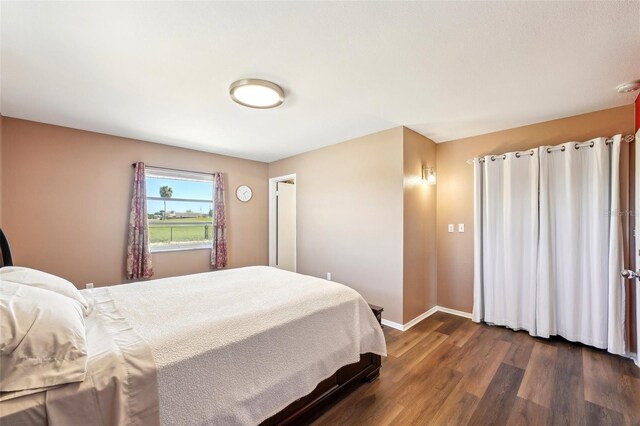 1021 Augusta Dr, Sun City Center, FL 33573 - bedroom with dark wood finished floors and baseboards